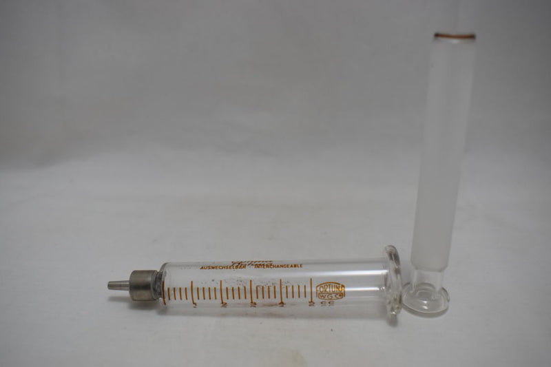 OPTIMA (Fortuna W.G.Co) GLASS HYPODERMIC SYRINGE (LUER-LOCK tip) with interchangeable components / Reusable / Γυάλινη Σύριγγα με μεταλλικό σύνδεσμο ασφαλείας, επαναχρησιμοποιήσιμη 5 c.c. +  STAINLESS STEEL NEEDLES / ΒΕΛΟΝΕΣ No 12 Μια Ντουζίνα (Δωδεκάδα).