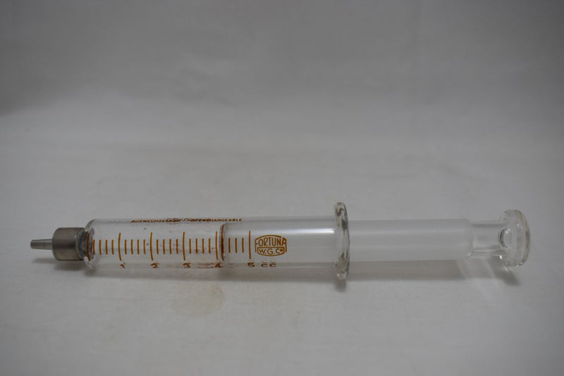 OPTIMA (Fortuna W.G.Co) GLASS HYPODERMIC SYRINGE (LUER-LOCK tip) with interchangeable components / Reusable / Γυάλινη Σύριγγα με μεταλλικό σύνδεσμο ασφαλείας, επαναχρησιμοποιήσιμη 5 c.c. + STAINLESS STEEL NEEDLES / ΒΕΛΟΝΕΣ No 14 Μια Ντουζίνα (Δωδεκάδα).