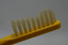 KENT OF LONDON ORIGINAL TOOTHBRUSH (MEDIUM) CURVED TUFT REAL BRISTLE YELLOW COLOR (VERSION 1977) / ΟΔΟΝΤΟΒΟΥΡΤΣΑ ΜΕ ΚΑΜΠΥΛΕΣ ΚΑΙ ΑΥΘΕΝΤΙΚΕΣ ΤΡΙΧΕΣ (ΜΕΣΑΙΑΣ ΣΚΛΗΡΟΤΗΤΑΣ) ΧΡΩΜΑΤΟΣ KΙΤΡΙΝΟΥ.